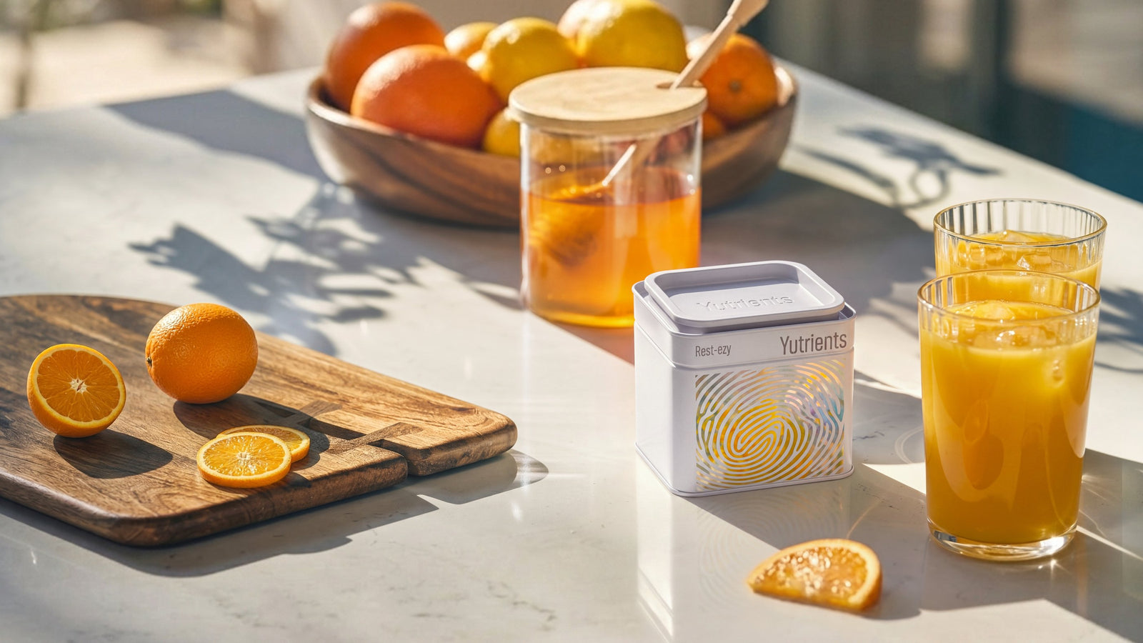 A Yutrients tin on a sunlit kitchen worktop beside a glass of orange juice