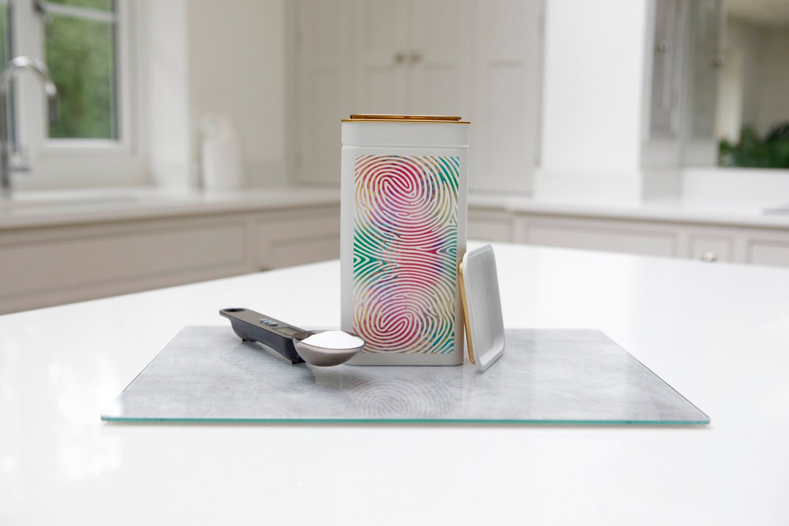 A Yutrients tin on a kitchen counter with a precision spoon-scale