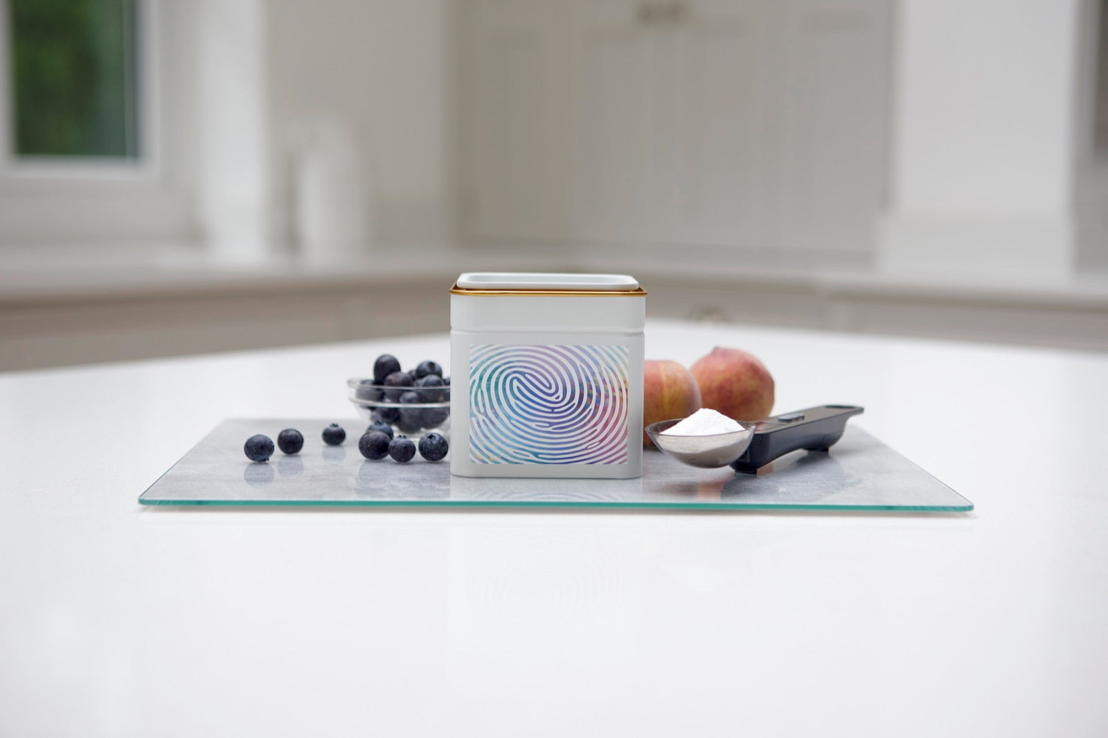 A Yutrients tin labelled My Formula on a kitchen counter with fresh ingredients