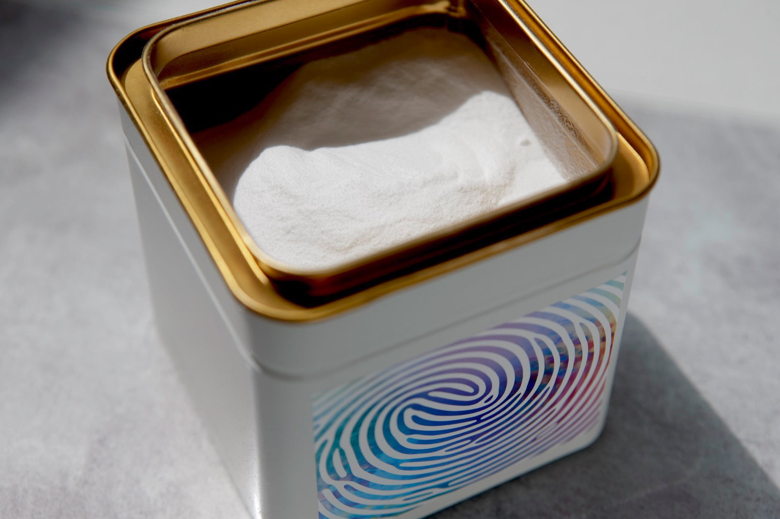 An open Yutrients tin showing the blended powder inside
