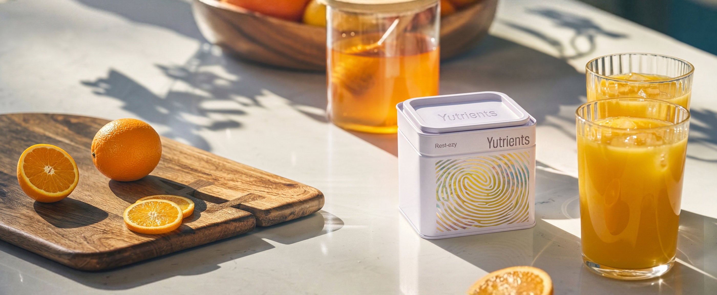A Yutrients tin on a sunlit kitchen worktop beside a glass of orange juice